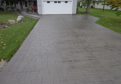Stamped concrete driveway made to look like a pavers.