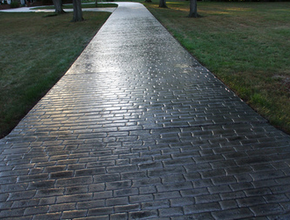 Polished gray brick style stamped concrete driveway.