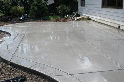 Polished plain gray concrete, with a textured concrete edge.