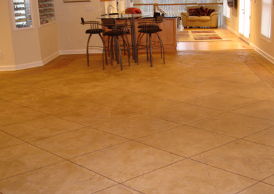 Stamped concrete in a kitchen made to look like textured designed tile.