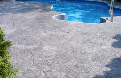 Light gray stamped concrete pool deck.